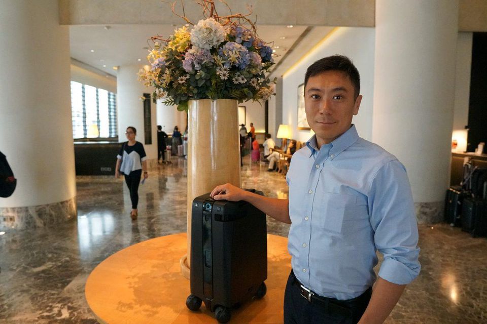 Forward X founder Nicholas Chee with the Ovis a self driving robot suitcase
