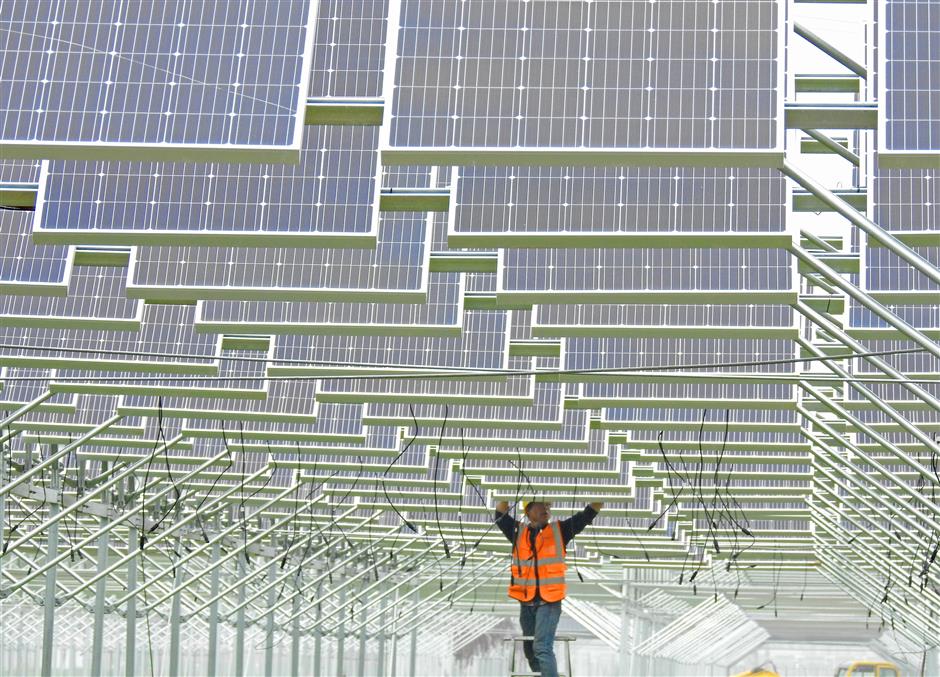 A Chinese worker installs solar panels at a photovoltaic power station in Lianyungang city east Chinas Jiangsu Province
