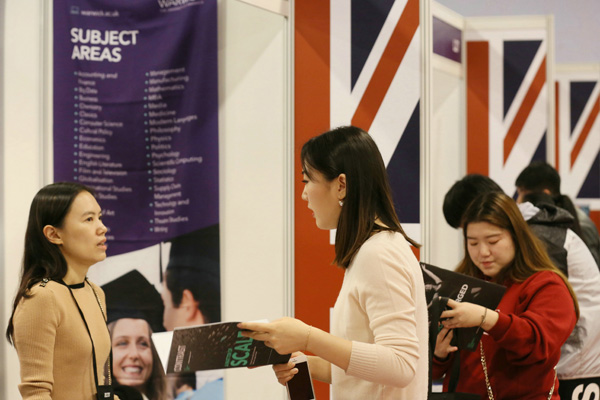 A visitor consults at the UK counter at China Education Expo in Beijing in October 2017