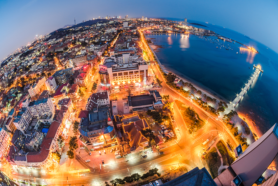 This birds eye view of Qingdao Shandong province features the city at night