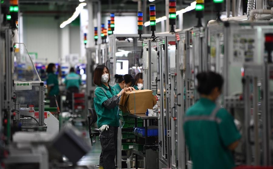 People work at the workshop of Schneider Electric Low Voltage Tianjin Co. Ltd. in Tianjin