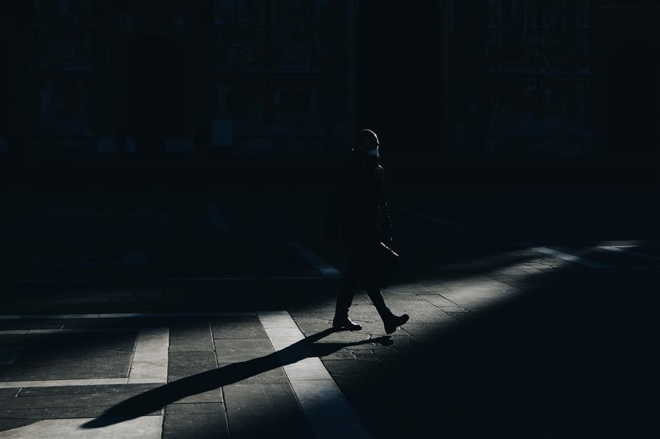 Empty streets in Milan Italy on March 11 as a man wearing a face mask in Piazza Duomo as restrictive measures are taken to contain the coronavirus outbreak
