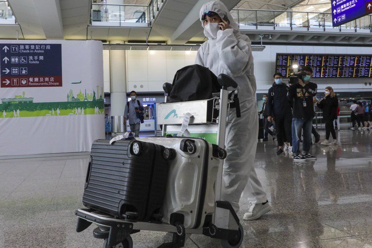 A traveller takes anti infection precautions at Hong Kong International Airport