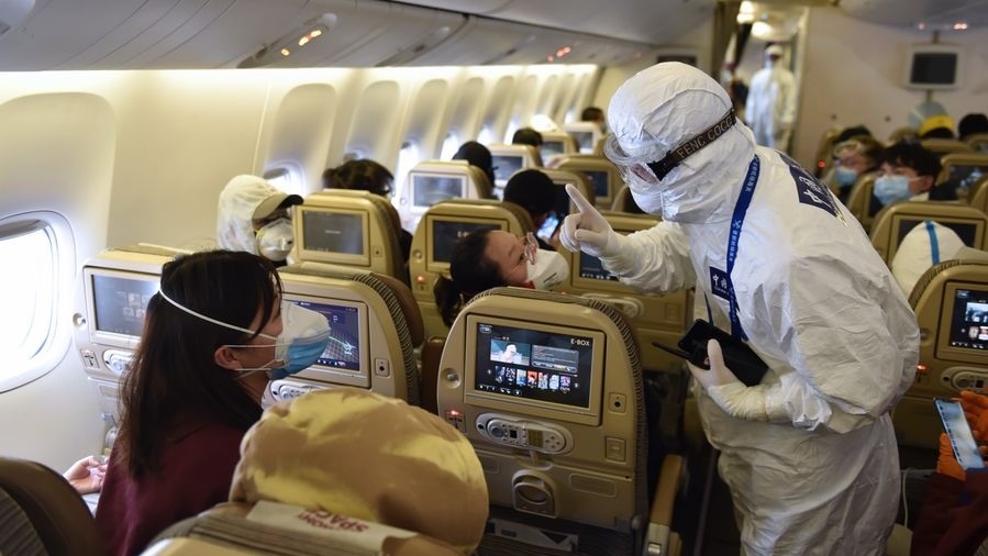A customs officer answers questions for inbound passengers on a flight at the Capital International Airport in Beijing