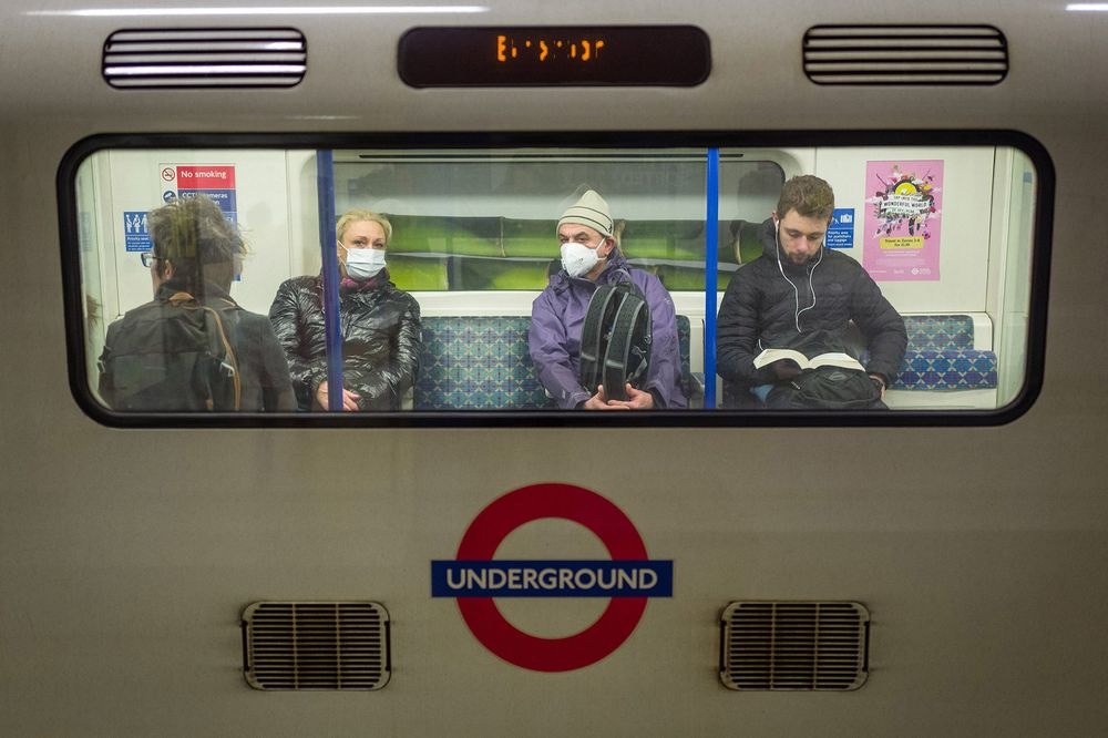 Passengers wear protective face masks as they travel on an underground train in London on March 15