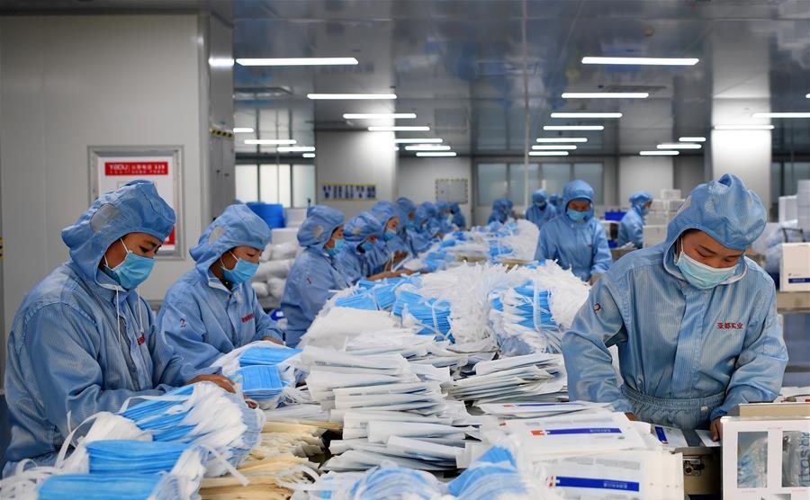 Workers make face masks at the workshop of a company in Changyuan central Chinas Henan Province