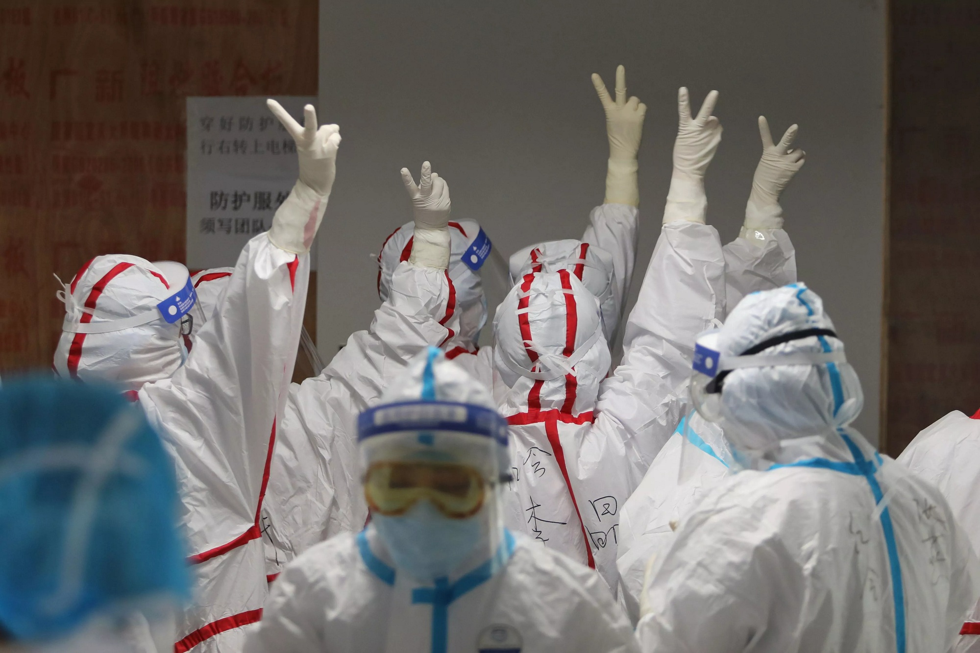 Medical staff cheer before going into an ICU ward for coronavirus patients at the Red Cross Hospital in Wuhan in Chinas central Hubei province on Monday