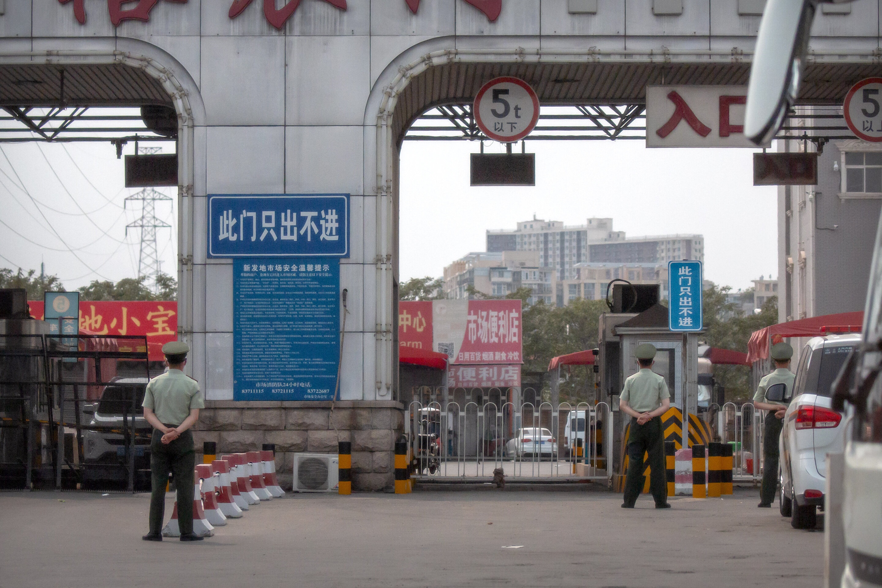 Chinese paramilitary police stand guard at barricaded entrances to the market