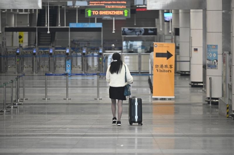 A woman walks to the departure hall of Shenzhen Bay Port Hong Kong Port Area