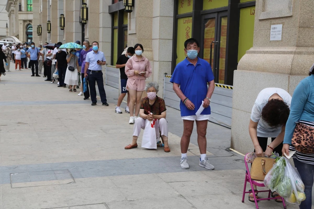 People queue to give samples in Dalian which is testing its entire six million population for Covid 19