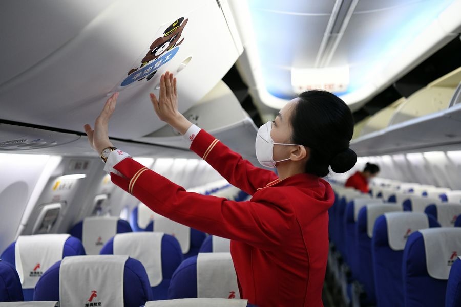 Stewardesses make preparations on flight ZH9127 of Shenzhen Airlines