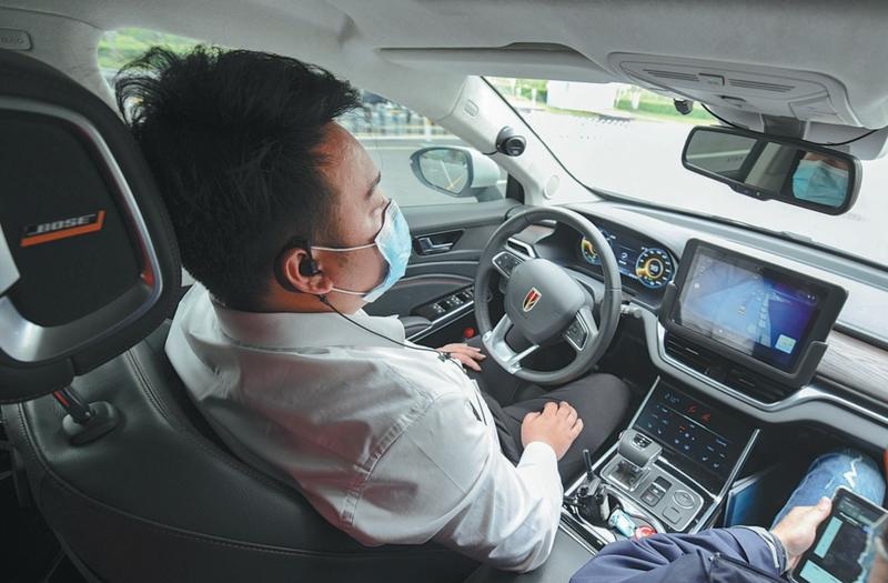 A vehicle safety inspector sits in a selfdriving Robotaxi