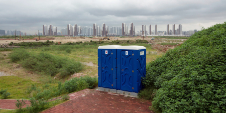 BT 201806 Last words Portable toilets are seen in front of skyscrapers at the Qianhai special economic zone in Shenzhen