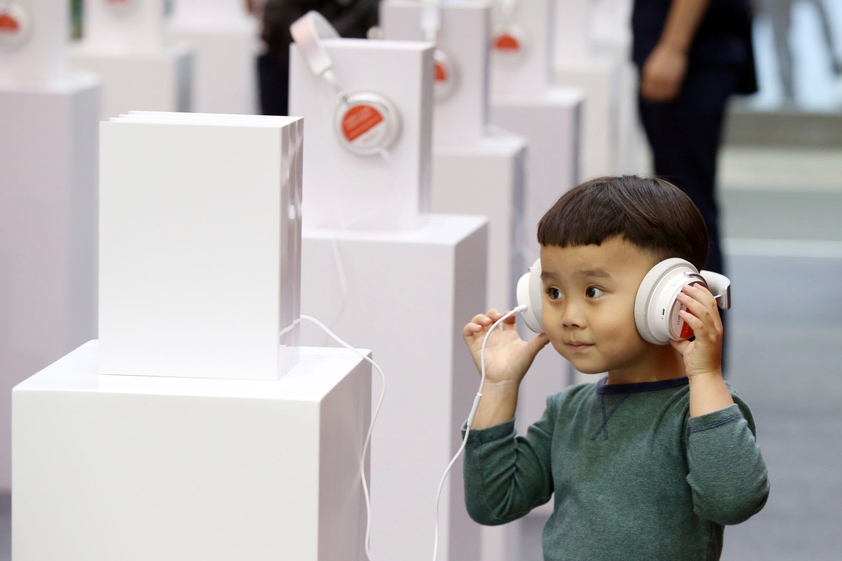 BT 201906 FEATURE A child tries out an audio book at a Ximalaya booth during a book fair in Shenzhen Guangdong province