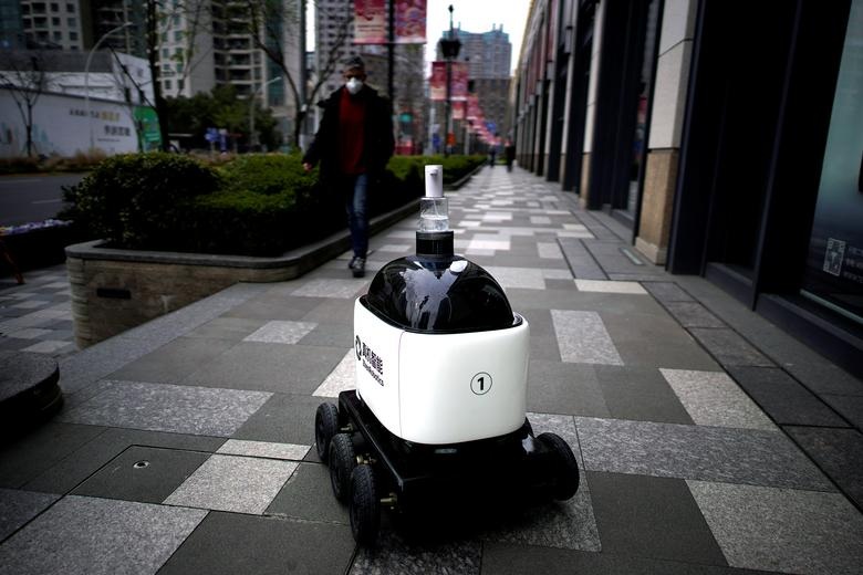 A robot with a dispenser for hand sanitizer goes around a shopping complex as the country is hit by an outbreak of the novel coronavirus in Shanghai