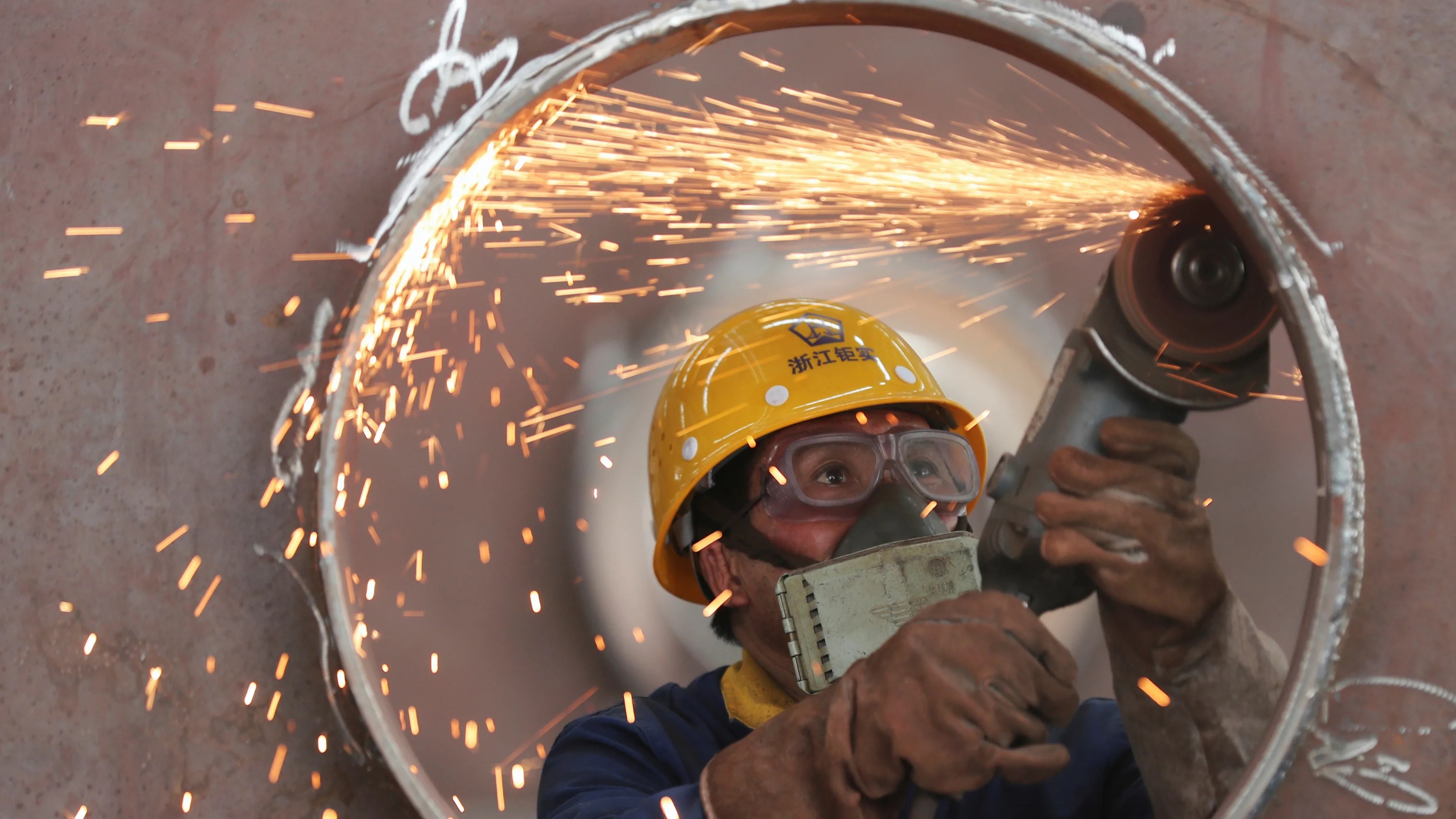 An employee works on a production line manufacturing steel structures at a factory in Huzhou