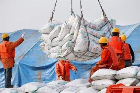 BT 201805 Economy 05 Workers move bags of soybean meal at a port in Nantong Jiangsu province China